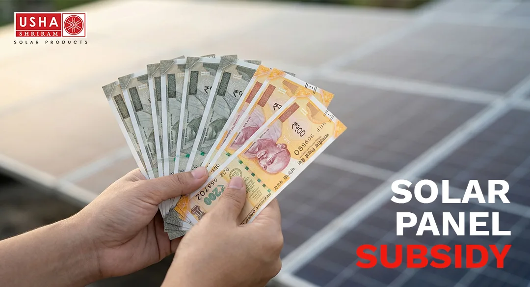Hands holding Indian currency notes representing rooftop solar panel subsidy savings in India